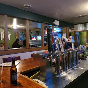 a bar with a row of beer taps