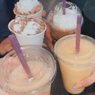 people holding cups of drinks