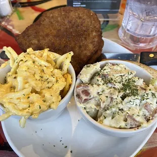 Pork chops with mac and cheese and potatoes salad.