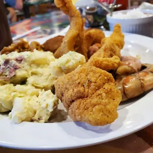 Fish, shrimp, crab cake, potato salad,  boiled shrimp, hush puppy