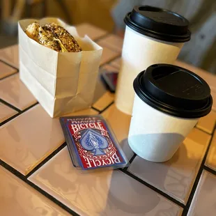 Everything bagel with salmon, medium and large coffee, super fun rummy playing cards.