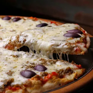 a pizza with olives and cheese