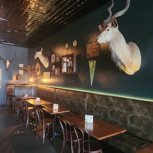 a dining area with tables, chairs, and taxi head mounted on the wall