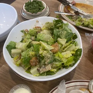 a plate of salad and a bowl of fries