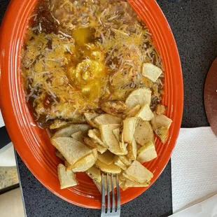 Huevos rancheros, eggs over easy &amp; crispy potato slices.