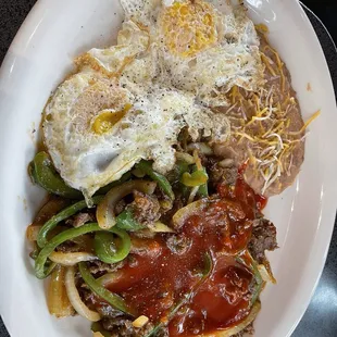 Steak rancheros with eggs over easy.