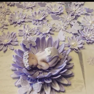 a baby sleeping on a flower