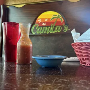 a table with a bowl of salsa