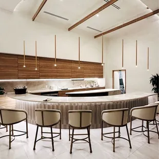 a kitchen with a bar and chairs