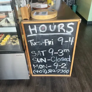 a chalkboard sign for hours