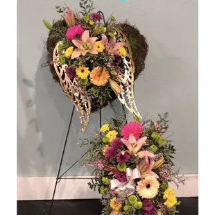 Funeral spray with Angel wings and moss heart