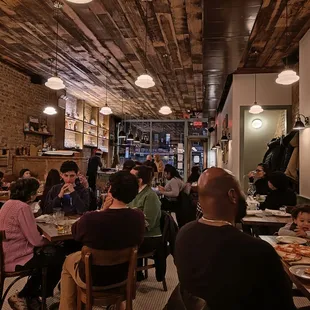 a crowded restaurant with people eating
