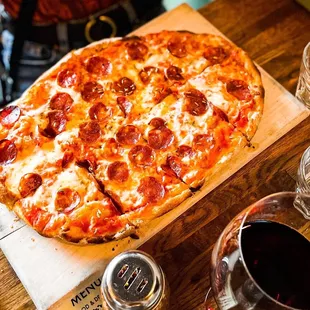 a pepperoni pizza on a cutting board