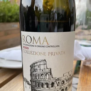 a bottle of wine on a wooden table