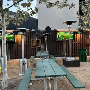 a green picnic table and televisions