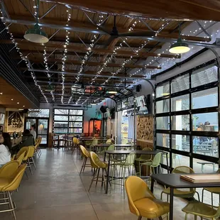 the inside of a restaurant with tables and chairs