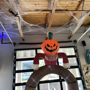 a fake pumpkin hanging from the ceiling