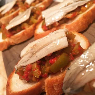 Bruschetta of boquerones, pequillo peppers and green olives.