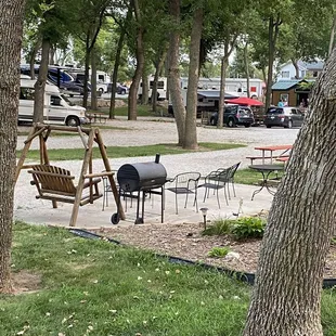 Unoccupied patio site with swing, grill, table/chairs