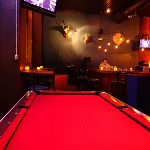 a pool table with a red cloth