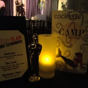 a lit candle and award
