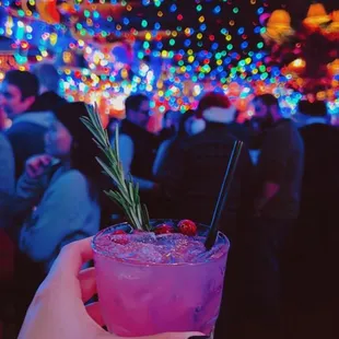 a person holding a cocktail