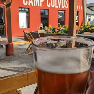 a person holding a glass of beer