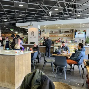 people sitting at tables in a cafe