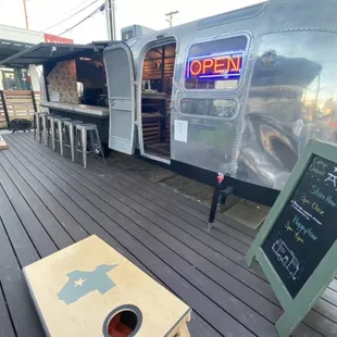 Comehole game and a cute little bar inside an old school trailer - merchandise inside