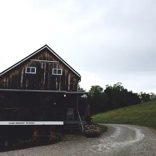 a rustic cabin on a gravel road