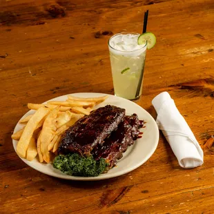 BBQ Ribs Steamed to &quot;fall-off-the-bone&quot; tenderness, Jack Daniels BBQ sauce, potato, coleslaw and bread.