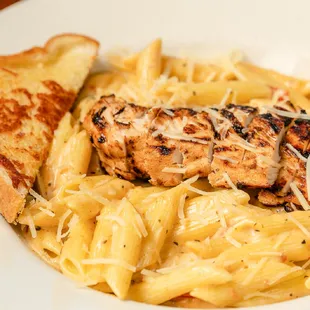Jerk Chicken Pasta Grilled chicken, spicy rum cream sauce, penne, roasted red peppers, sun-dried tomatoes, Parmesan and garlic bread.