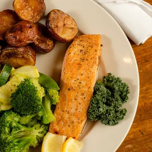 Salmon Atlantic salmon, broiled to order, herb butter, vegetable, potato and bread.