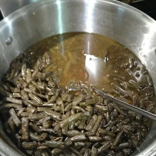 a pot of soup with a spoon in it