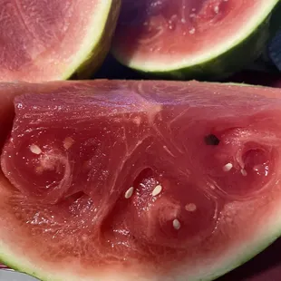 a slice of watermelon on a cutting board