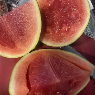 three slices of watermelon on a cutting board