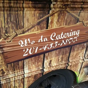 the side of a camper with a sign on it