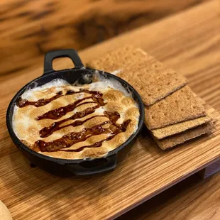 a skillet of food on a wooden table