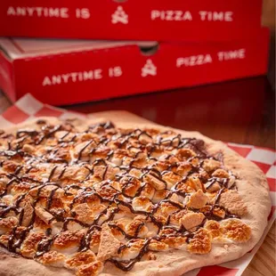 a campfire pizza and a pizza box