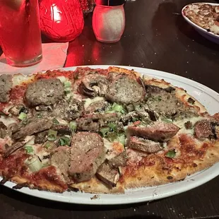 Small meatball pizza with mushrooms and green onions. Amazing flavor!