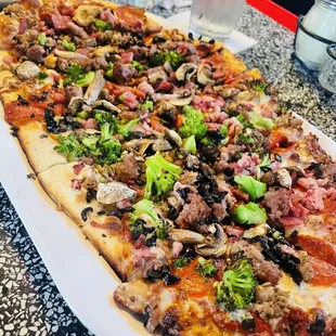 Meat Supreme Pizza with broccoli, mushrooms, and black olives