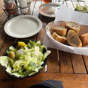 a picnic table with bread and salad