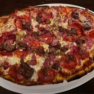 Small meat combo pizza hold the Canadian bacon.