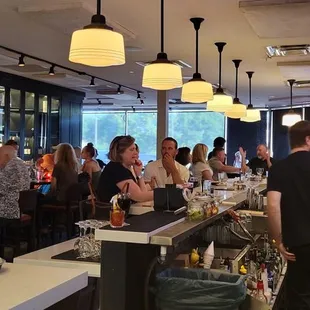 a crowd of people sitting at the bar