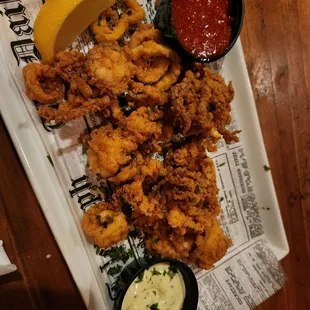 a plate of fried squids and dipping sauce