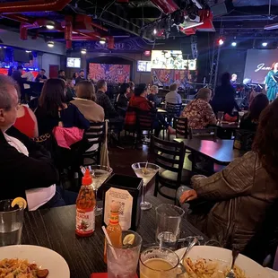 a group of people sitting at a table in a restaurant
