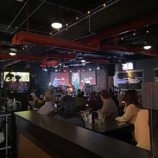 a group of people sitting at a bar