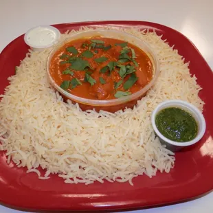 a plate of rice and a bowl of sauce