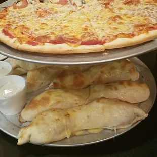 two pizzas stacked on plates