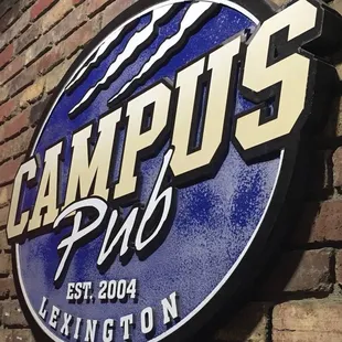 a sign on a brick wall